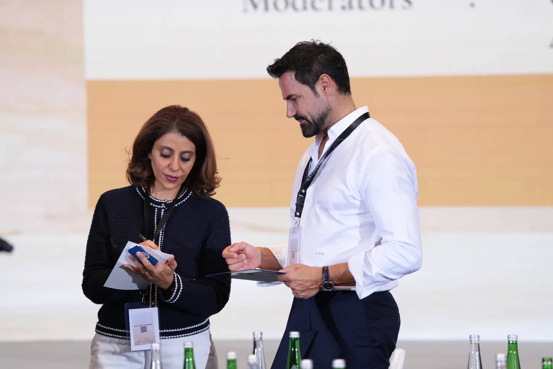 Dr. Christeen Youssef conferring with a fellow moderator between sessions.